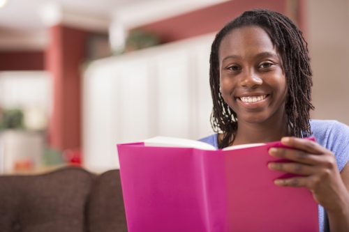 Adolescent Black girl reading a book